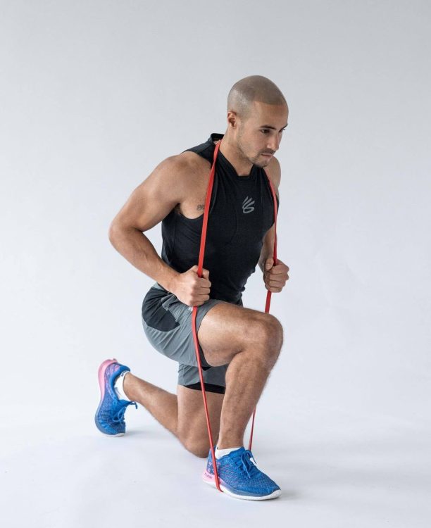Man performing end of a banded reverse lunge - resistance band leg exercises