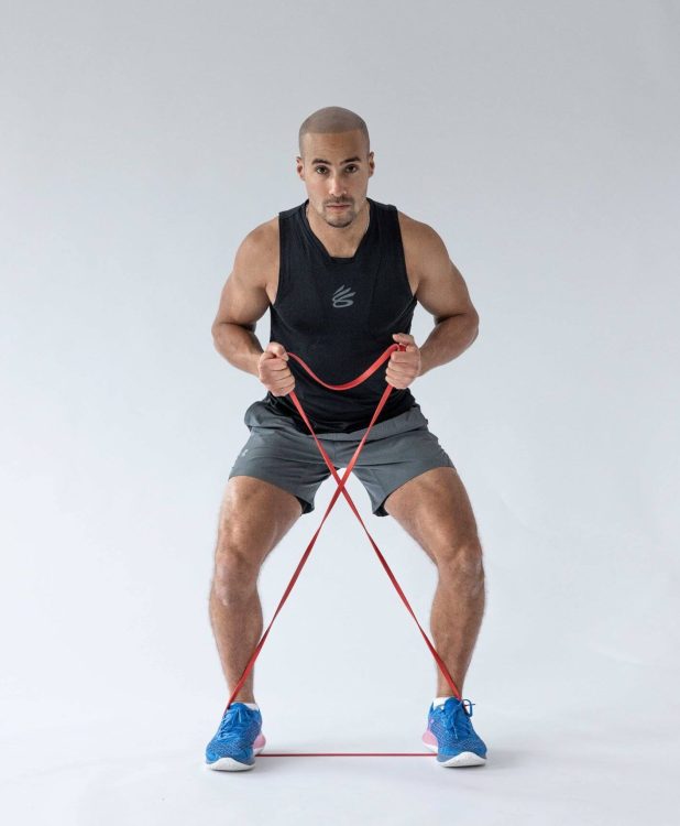 Man performing banded side steps - resistance band leg exercises