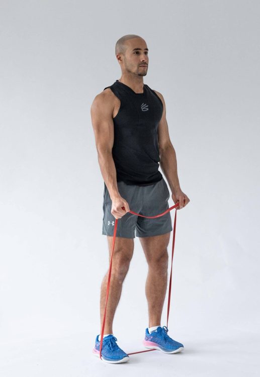 Man performing a banded biceps curl - resistance band arm exercises