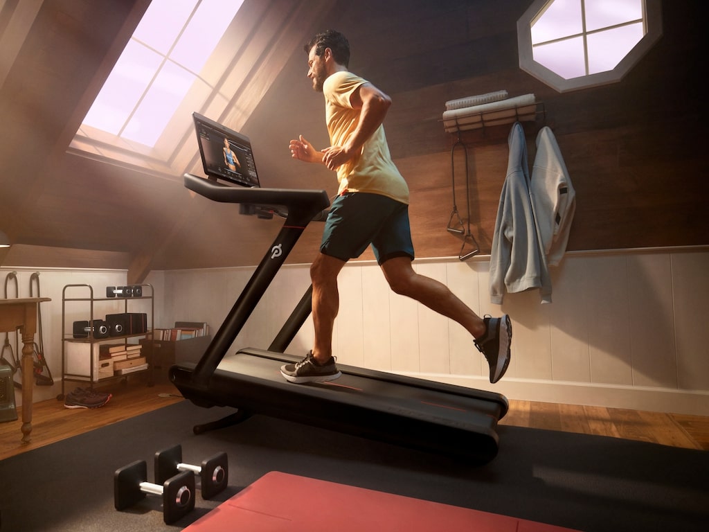 Man running on Peloton Tread in home gym