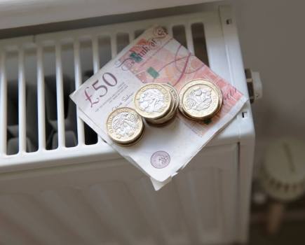 radiator with money on it to demonstrate cost of living crisis