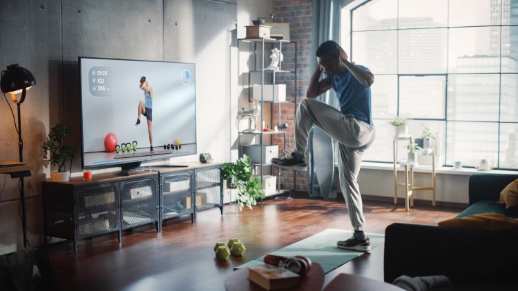Man exercising in front of tv