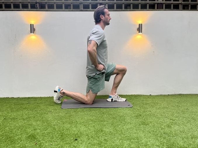 man demonstrates how to do half kneel hip flexor stretching exercises for beginners