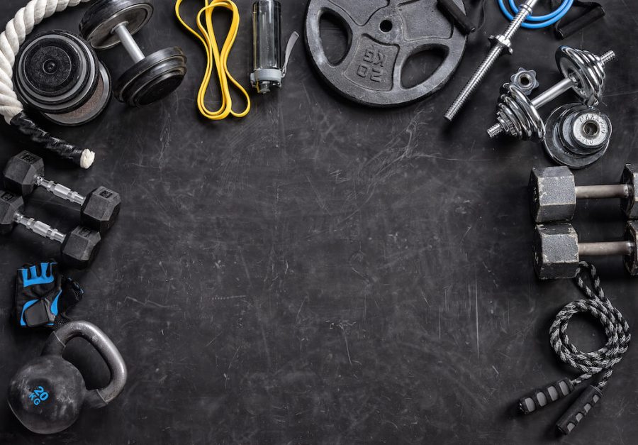 Assortment of gym equipment laid out on black gym floor