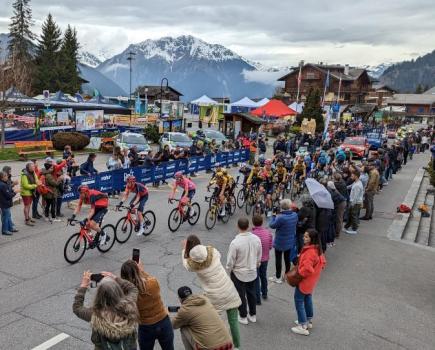 The Giro d'Italia bike race climbs past snow capped mountains