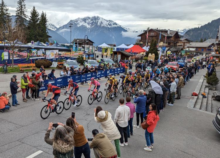 The Giro d'Italia bike race climbs past snow capped mountains