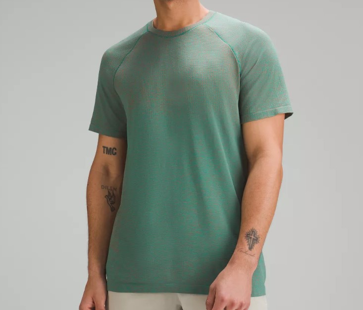 Pruct shot of a man wearing a green Lululemon Metal Vent Tech tee, roundup for the best gym shirts