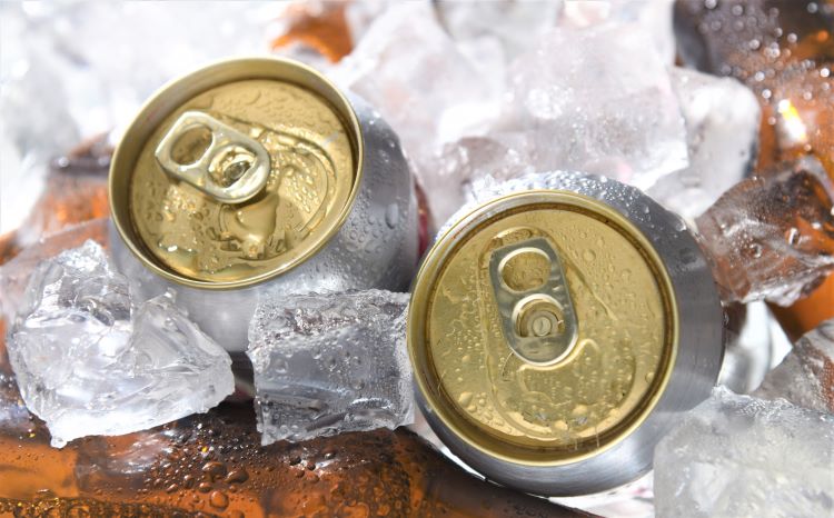 Cans of beer chilling over ice