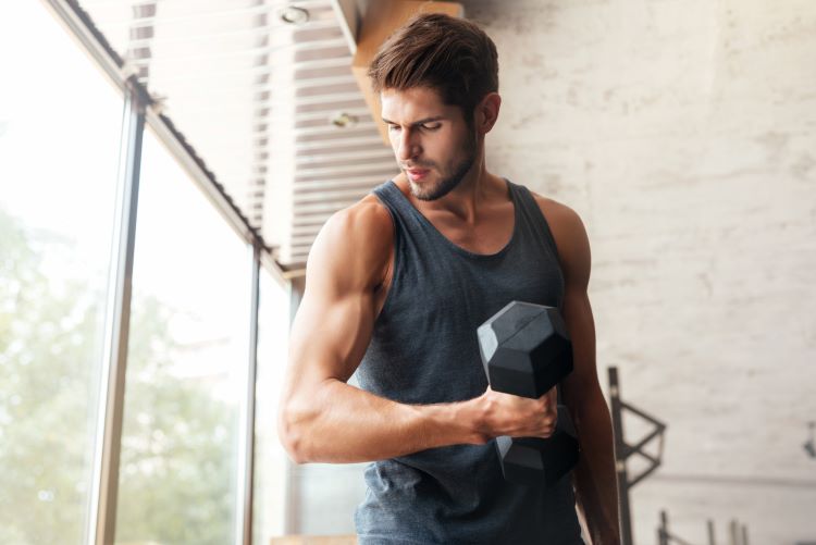 Man at home working out with dumbbells