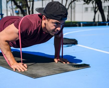 Man performing press-ups with a resistance band