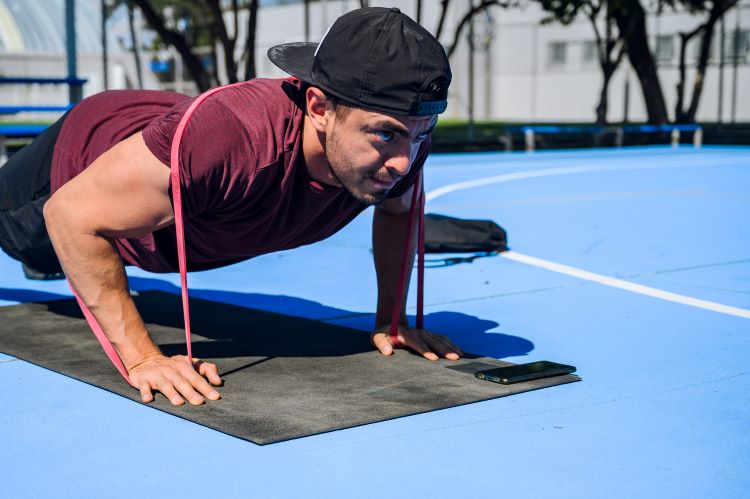 Man performing press-ups with a resistance band