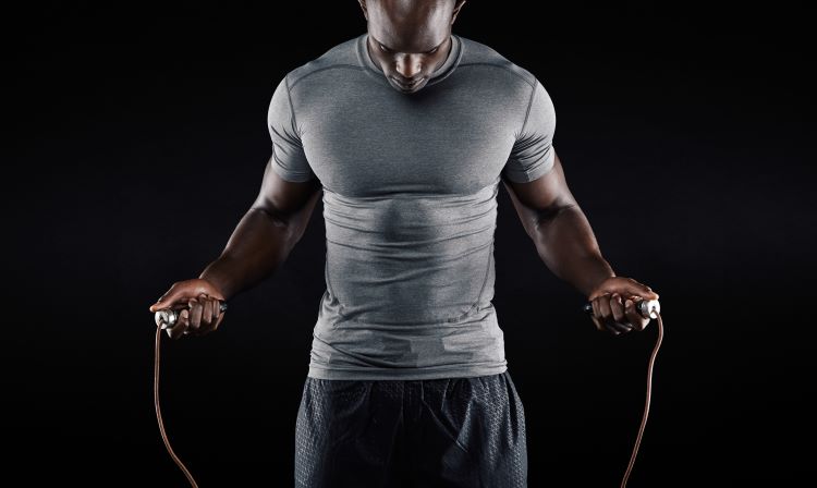 Close up of a man working out with a skipping rope