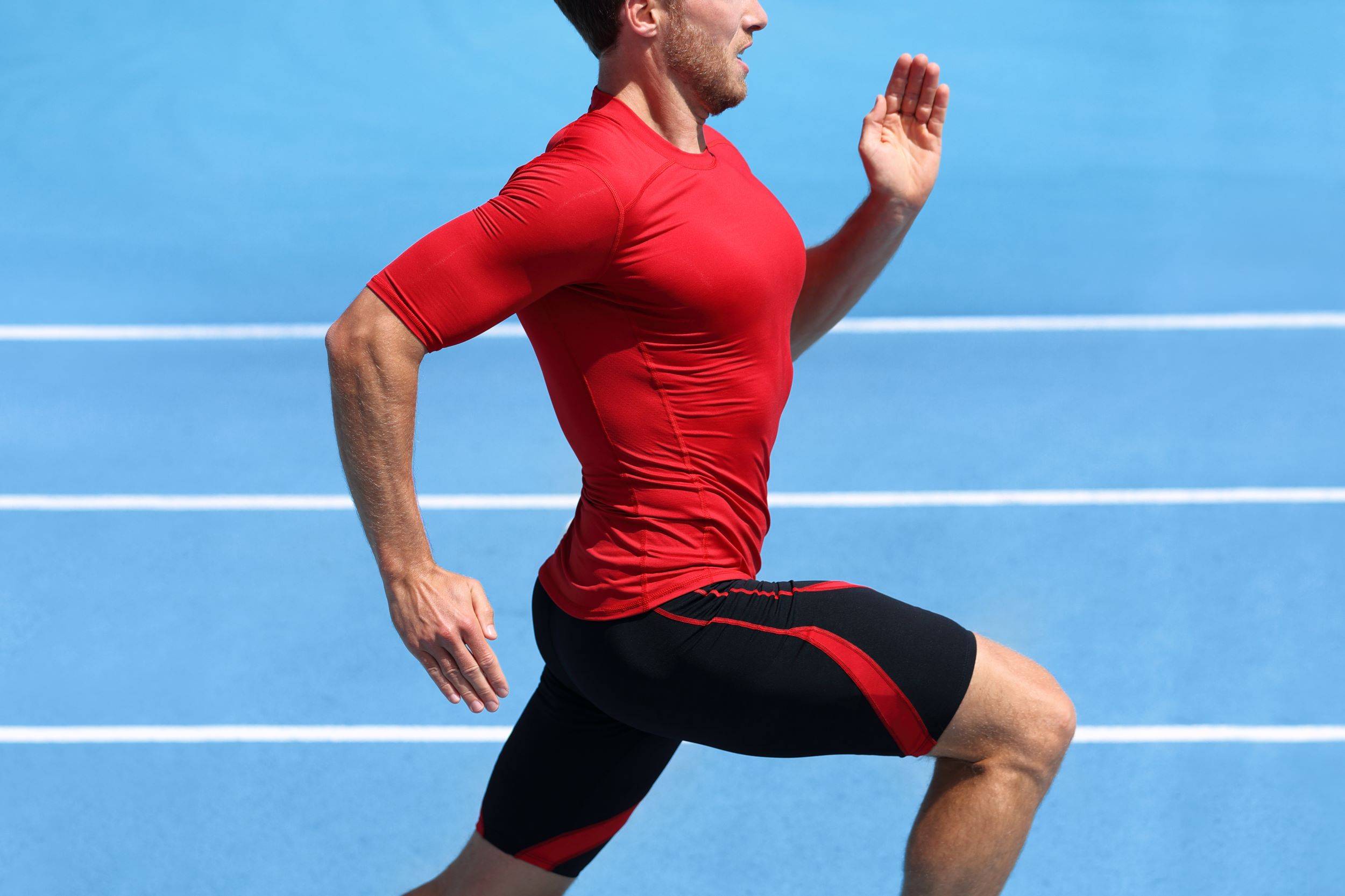 A man running on track in compression clothing