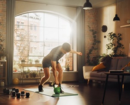 man performing home workout in apartment