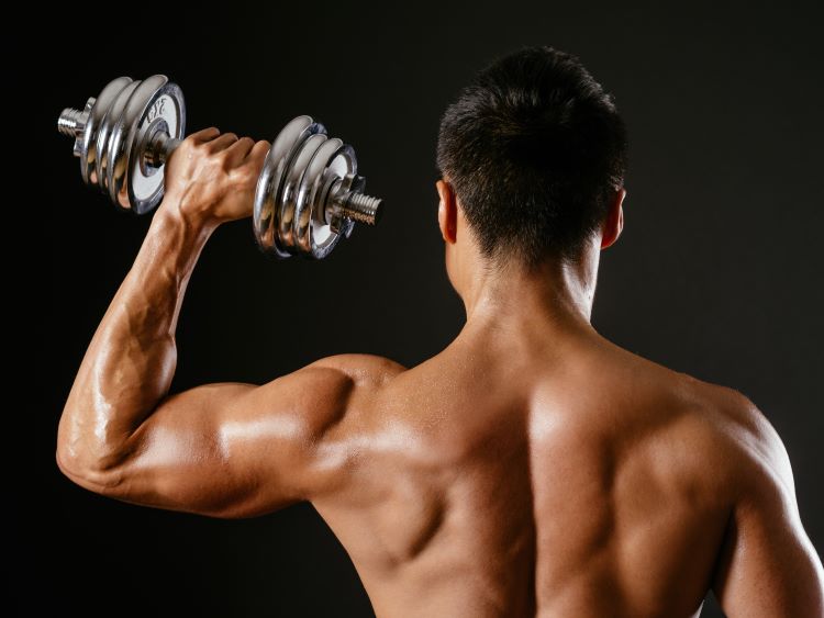 Close-up of man performing a single dumbbell press