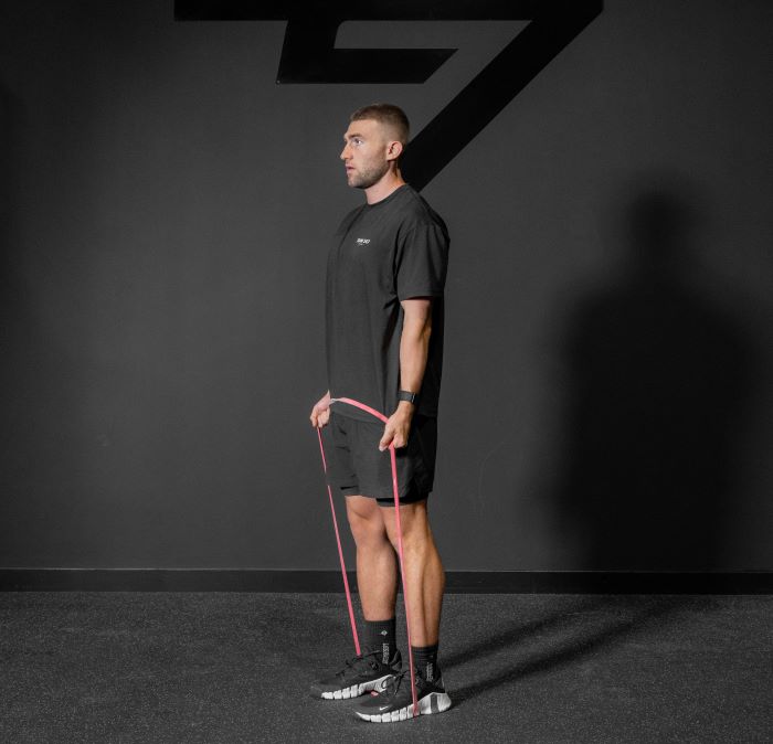 Man performing a resistance band biceps curl