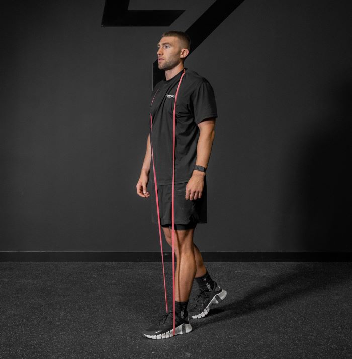 Man performing a resistance band reverse lunge