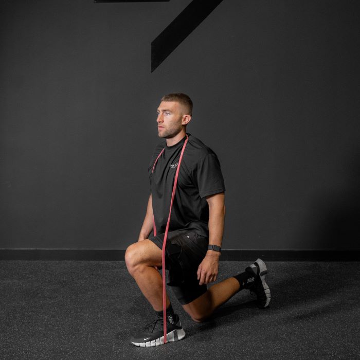 Man performing a resistance band reverse lunge
