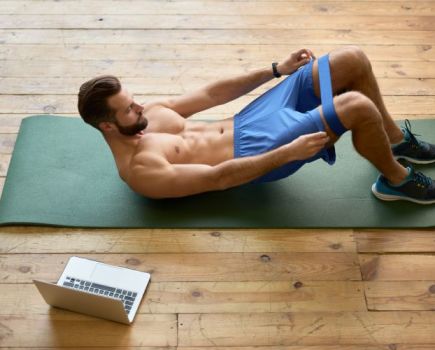 Man lying down exercising with a mini resistance band