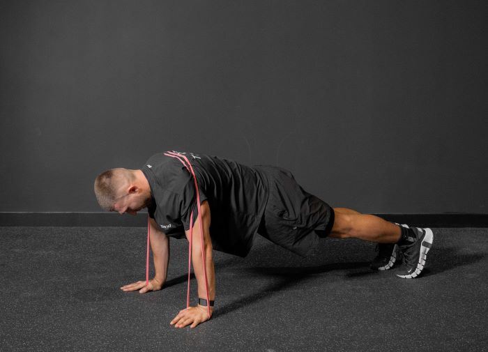 Man performing a resistance band press up