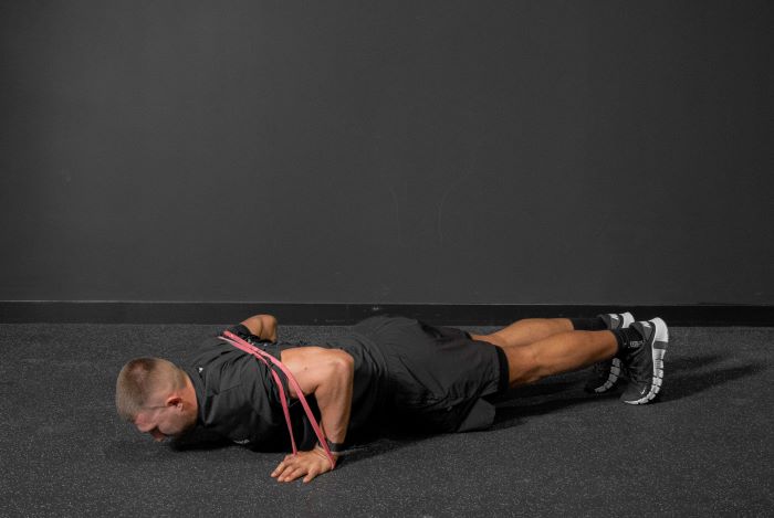 Man performing a resistance band press up