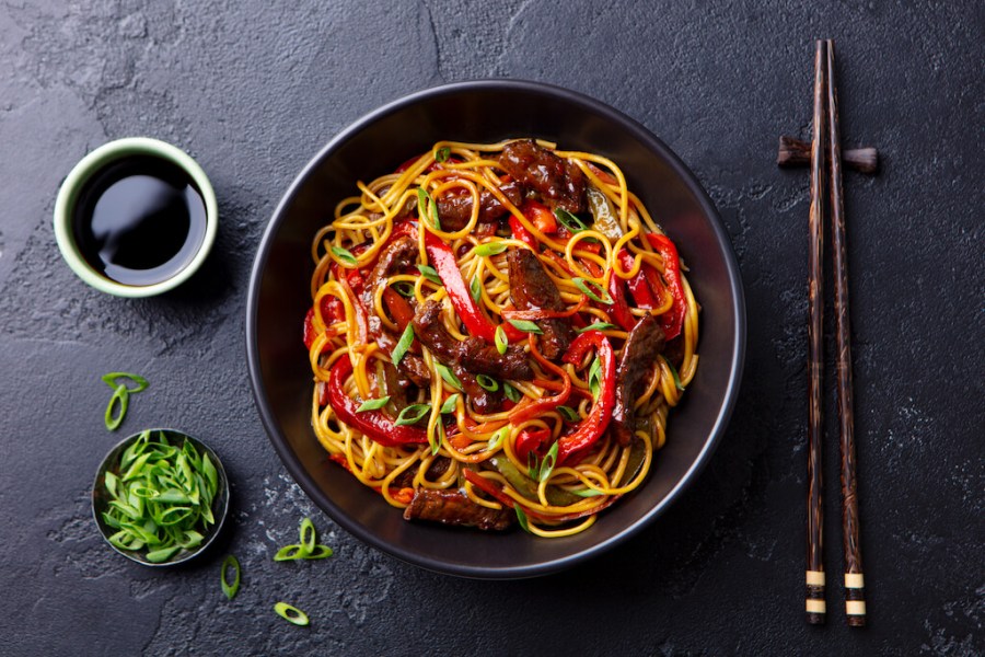 Stir-fry noodles with pot of soy sauce and chopsticks