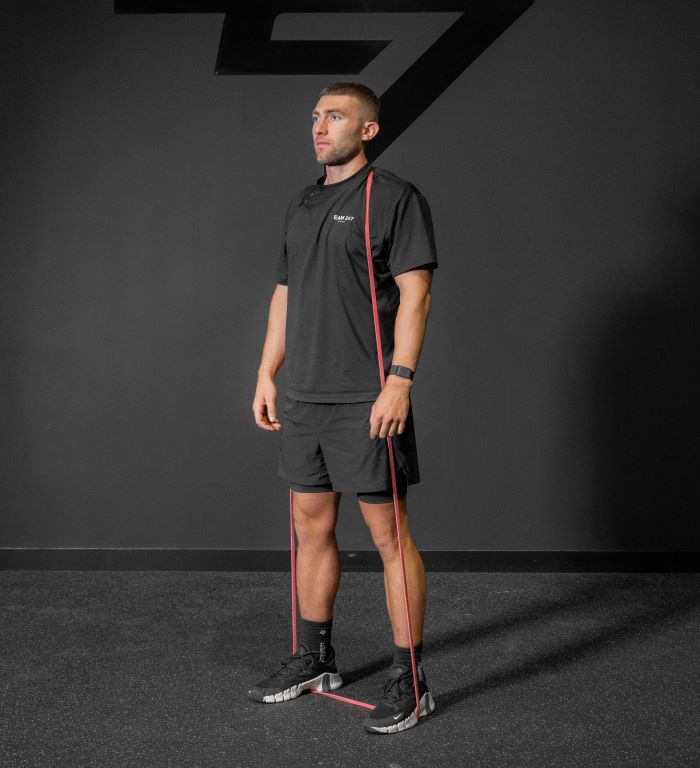 Man performing a resistance band squat