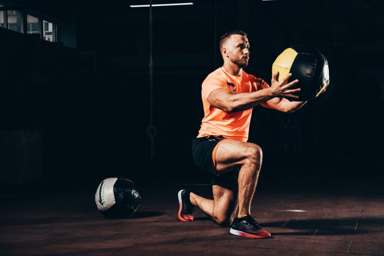 Man in gymwear working out with gym balls