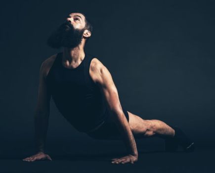 Bearded man performing a cobra stretch