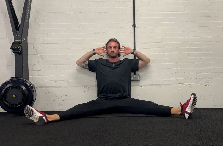 Man performing QL stretch - best back stretches