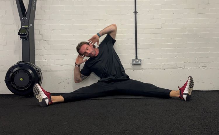 Man performing QL stretch - best back stretches