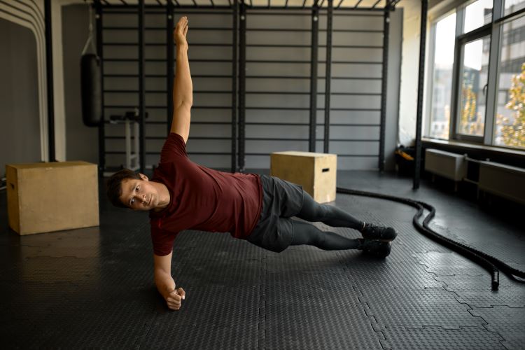 Man in a gym doing mobility exercises