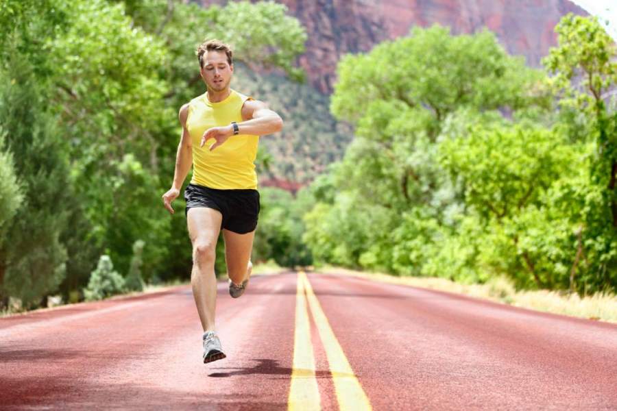 man running on road wearing 3-inch running shorts