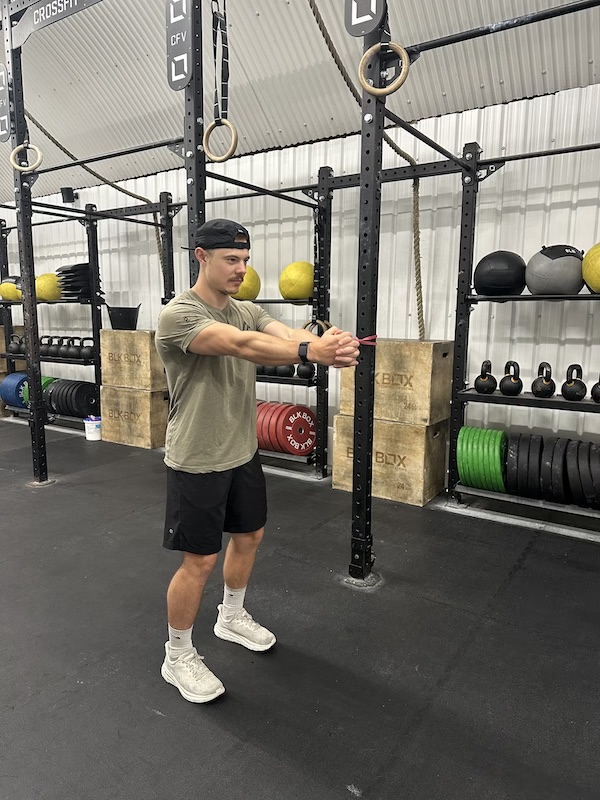 Personal trainer demonstrating band pallof press exercise