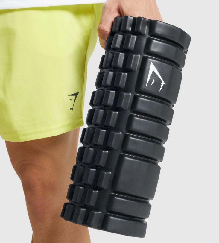 Product shot close up of a man holding a Gymshark foam roller