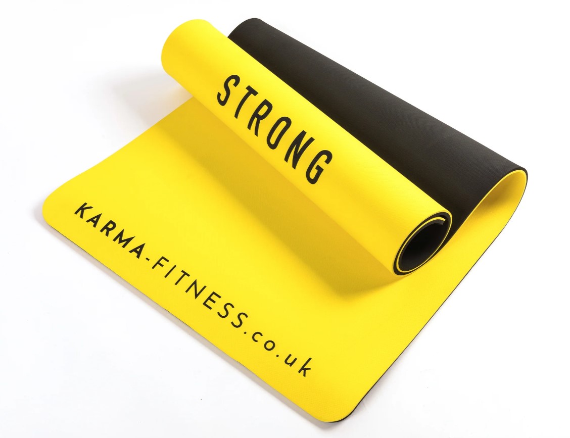 A partially rolled up yellow exercise mat