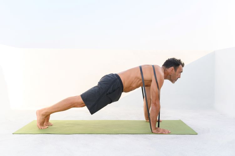 Man performing a resistance band press-up