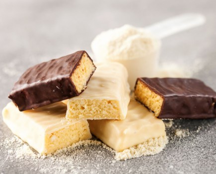 protein bars on table with whey protein and scoop