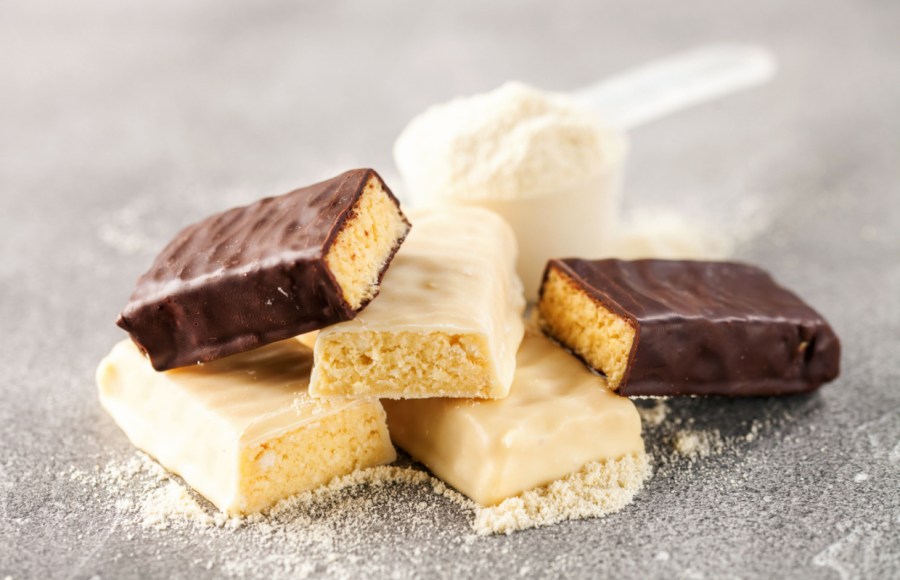 protein bars on table with whey protein and scoop