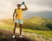 Male runner on a hill, drink a sports drink