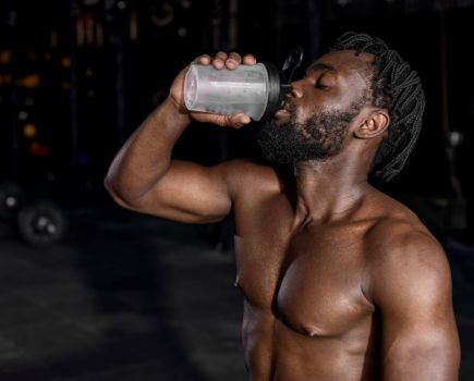 Man drinking a clear protein shake