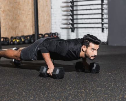 Man performing a dumbbell press-up