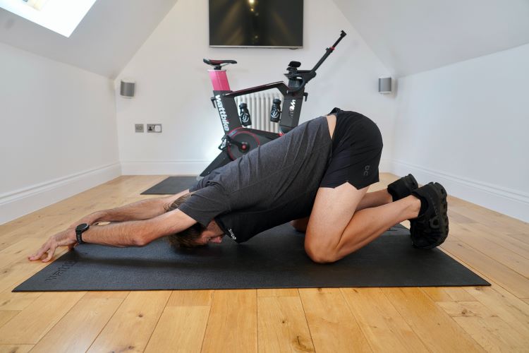 Man in home gym performing yoga pose
