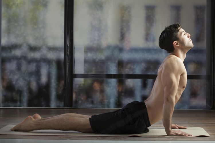Man performing upward dog yoga pose