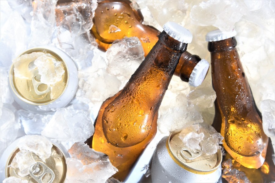 beer bottle and can chilled in ice