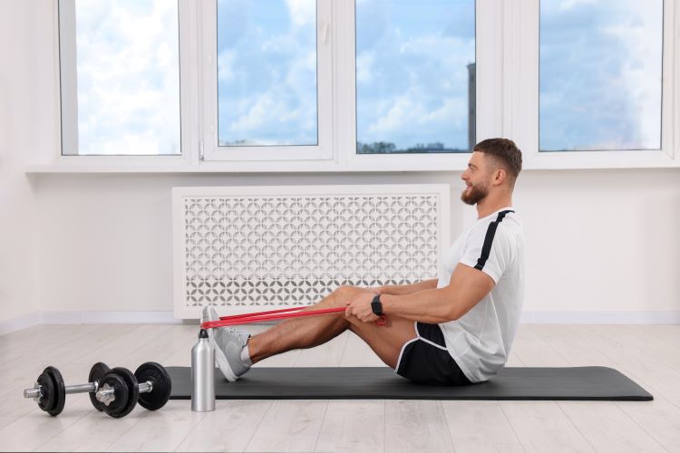 Man exercising with resistance bands and dumbbells