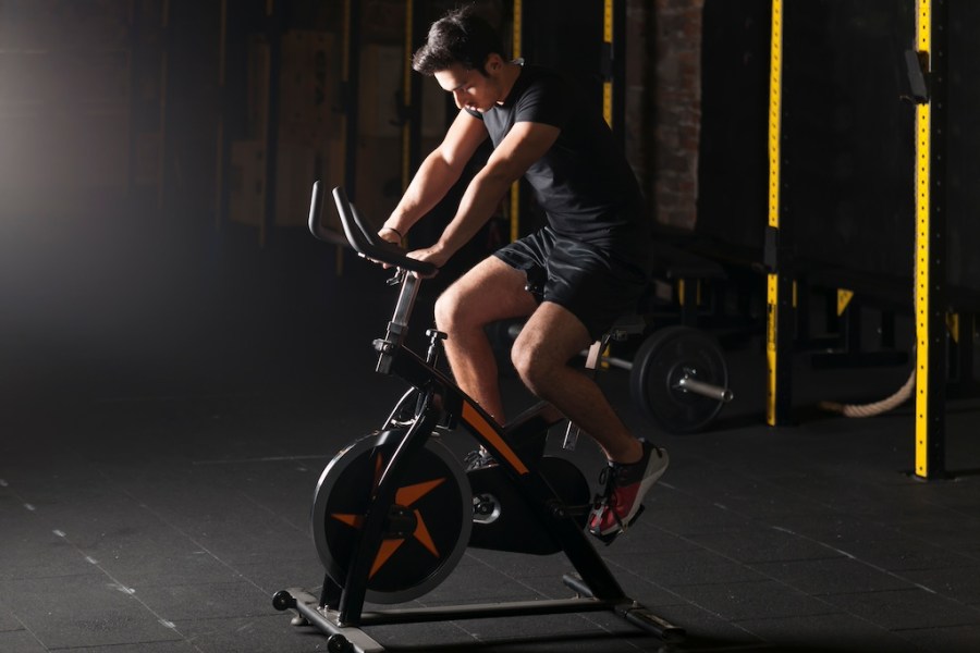 man riding exercise bike in a gym