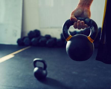 Close up of a man's hand holding a kettlebell
