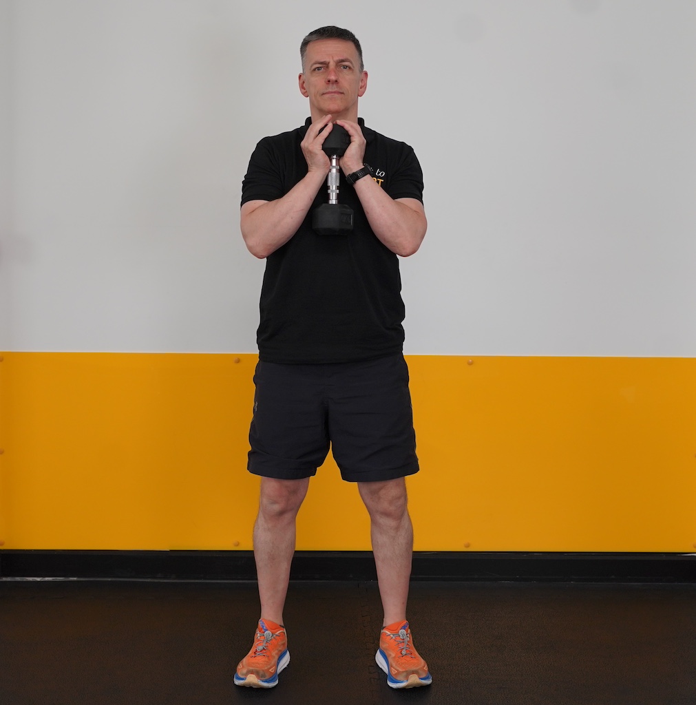 man performing dumbbell squat to show how to strength train in your sixties