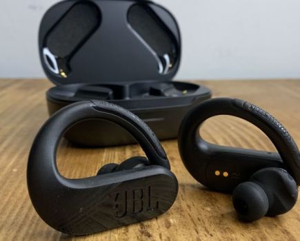 Pair of sports earphones and case on a table